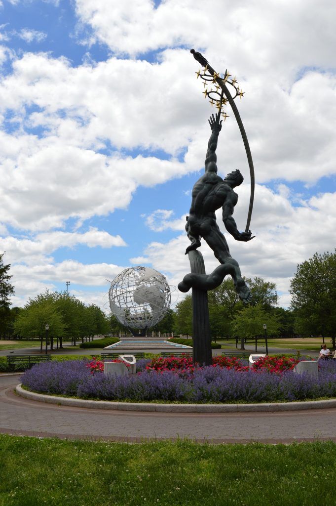 Rocket Thrower statue in Flushing Meadows-Corona Park with Unisphere in Background