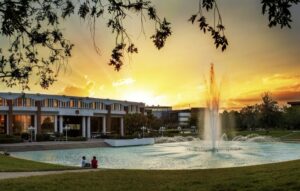UCF Millican Hall and Reflecting Pond at  sunset.